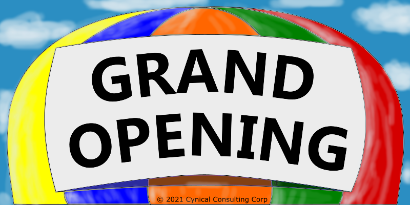 Top of a hot air balloon with yellow, blue, orange, green and red panels and a white sign containing "GRAND OPENING".